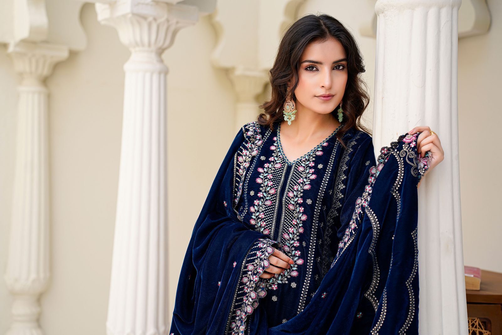 Black-and-white editorial portrait of a hand-embroidered ASHQA cape
