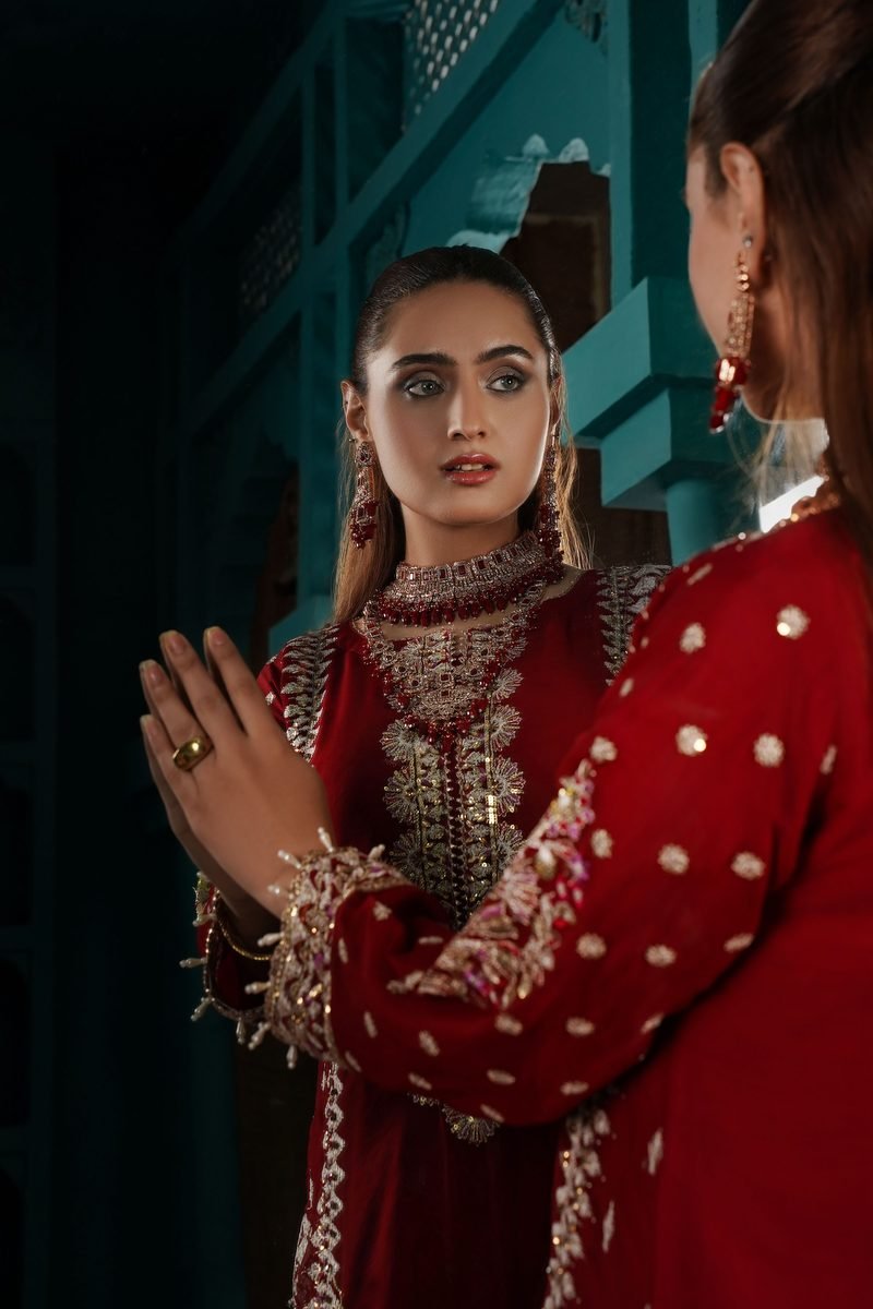 Model in a richly embroidered red ASHQA suit